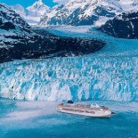 Alaskan Glacier A Glacier in Alaska flows out of the mountains and calves into the Pacific Ocean.